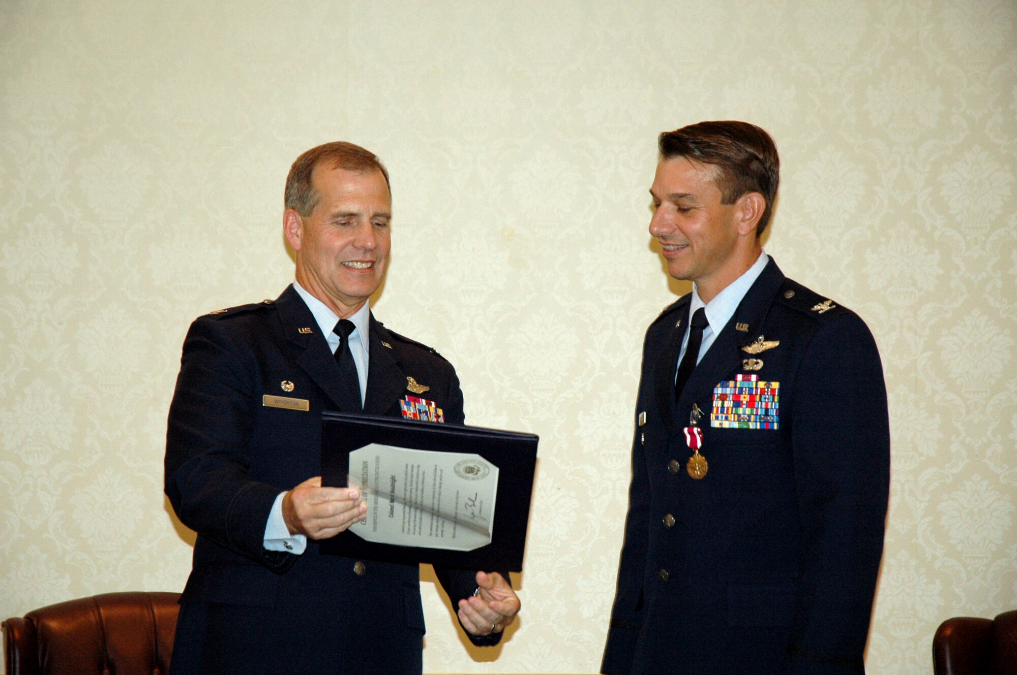 Colonel Mark Bauknight, 315th Airlift Wing Vice Commander is presented with his official retirement order by Colonel Timothy Wrighton, 315th Airlift Wing Commander.  Col. Bauknight retires after 23 years of military service. (U.S. Air Force photo/Staff Sgt. Jeff Kelly)