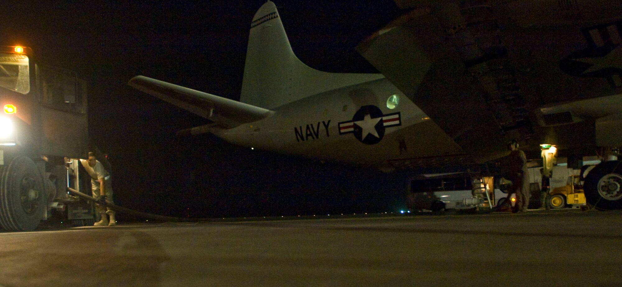 ALI BASE, Iraq -- Senior Airman Greg Crews, 407th Expeditionary Logistics Readiness Squadron fuels operator, turns on the fuel hose issuing JP-8 fuel to a Navy P-3 Aug. 22, 2008. The 407th ELRS Fuels Management Flight supports not only the Air Force, but is a critical asset for the Navy and Army providing the fuel needed 24 hours a day to ensure mission success. Crews is deployed from Hurlburt Field Air Force Base, Fla. (U.S. Air Force photo/Airman 1st Class Christopher Griffin)