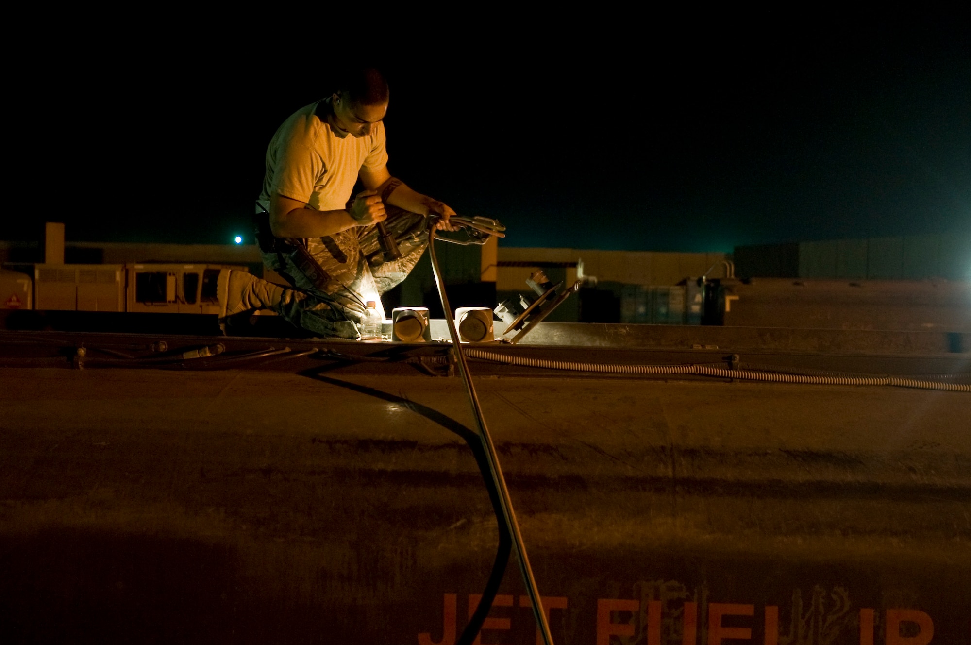 ALI BASE, Iraq -- Senior Airman Greg Crews, 407th Expeditionary Logistics Readiness Squadron fuels operator, tops off the fuel to his truck Aug. 22, 2008 The 407th ELRS Fuels Management Flight supports not only the Air Force, but is a critical asset for the Navy and Army providing the fuel needed 24 hours a day to ensure mission success. They are also responsible for distributing fuel to all of the power generators here. Crews is deployed from Hurlburt Field Air Force Base, Fla. (U.S. Air Force photo/Airman 1st Class Christopher Griffin)