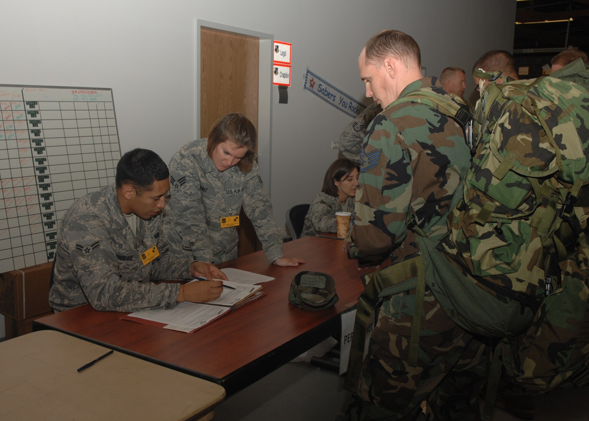 SPANGDAHLEM AIR BASE, Germany – Senior Airman Kindra Hunt and Airman 1st Class Manuel Andrade, 52nd Force Support Squadron, assist Airmen during the Personal Deployment Function portion of the exercise, Aug. 23, 2008. During the exercise, 52nd Fighter Wing Airmen met with numerous services including personnel, finance, and postal to prepare themselves for deployment.  (U.S. Air Force photo by Airman Staci Miller)