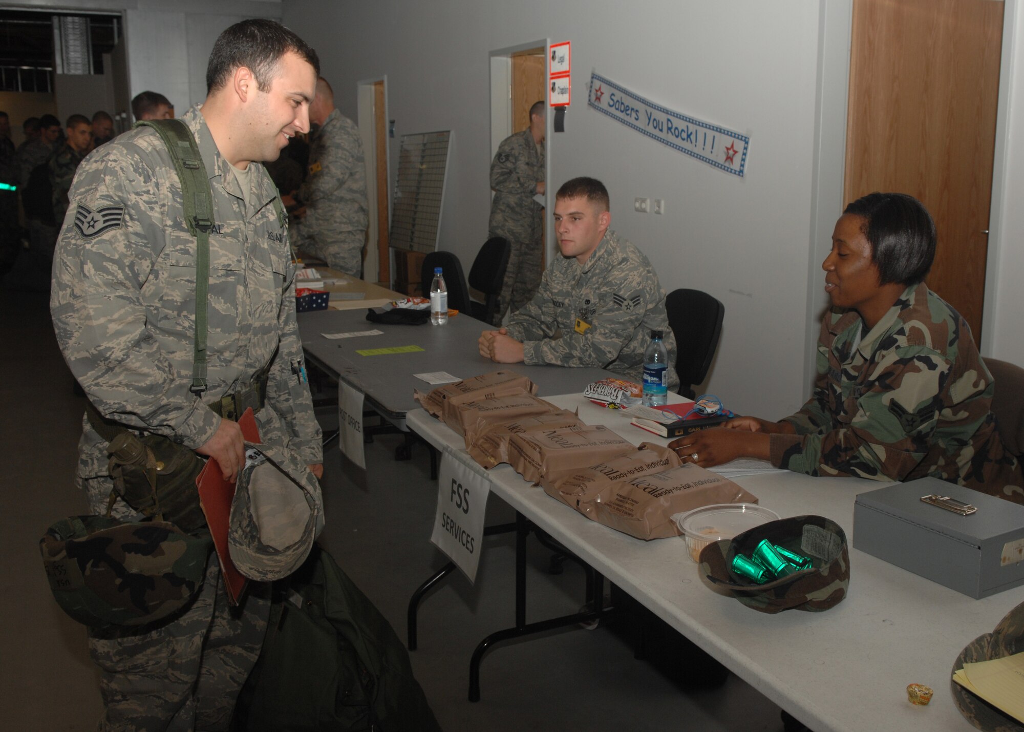SPANGDAHLEM AIR BASE, Germany – Staff Sgt. Julio Bernal, 52nd Component Maintenance Squadron, speaks with a representative from the 52nd Force Support Squadron during the Personal Deployment Function portion of the exercise, Aug. 23, 2008. During the exercise, 52nd Fighter Wing Airmen met with numerous services including personnel, finance, and postal to prepare themselves for deployment. (U.S. Air Force photo by Airman Staci Miller)