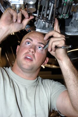 SOUTHWEST ASIA--Airman 1st Class Christopher Chartier from the 380th Expeditionary Aircraft Maintenance Squadron, removes a hydraulic package from an E-3 Sentry engine here Aug. 24. Each engine is line modifiable to fit either inboard or outboard positions. Airman Chartier is removing the package due to being sent an inboard engine where he needed an outboard engine. This was the 6th engine change in 120 days. The normal fix time to remove and replace an E-3 engine is 18 hours. The technicians here have sliced that time in more then half. Their average time to change an engine and replace the aircraft to flyable condition here is 8 1/2 hours. Airman Chartier is deployed from the 552nd Aircraft Maintenance Squadron, Tinker Air Force Base, Okla. his hometown is Yucca Valley, Calif.(U.S. Air Force photo/Tech. Sgt. Christopher A Campbell)(released)