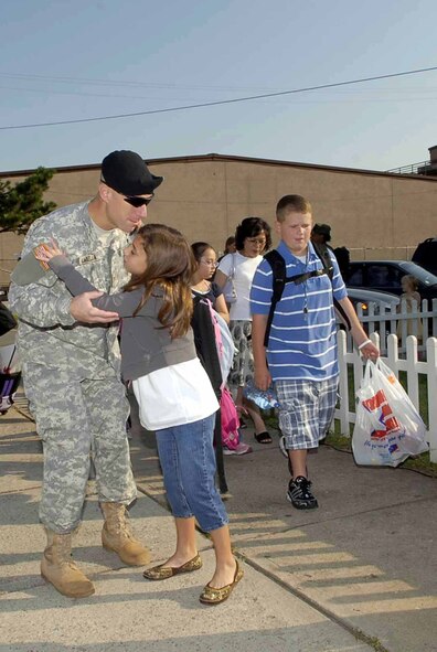 OSAN AIR BASE, Republic of Korea – Army Maj. Albert Labella, 35th Air Defense Artillery Brigade deputy commander, give his daughter, Sophia, a goodbye hug as her first day as a 5th grader begins. (U.S. Air Force photo/Staff Sgt. Scottie McCord)