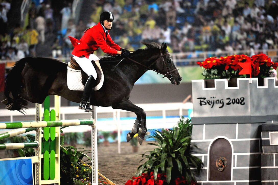 U.S. Air Force World Class Athlete Program Capt. Eli Bremer rides Dangdang to a 14th-place finish worth 1,060 points in the equestrian show jumping portion of the modern pentathlon at the Olympic Sports Center Stadium in Beijing, Aug. 21, 2008. 