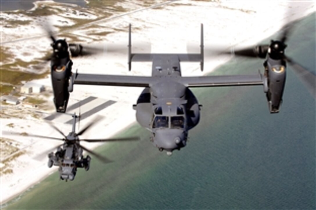 A CV-22 Osprey from the 8th Special Operation Squadron, and an MH-53 Pave Low from the 20th Special Operation Squadron, fly over the coastline near Hurlburt Field, Fla., Aug. 20, 2008. The MH-53 will officially retire October 2008 and the CV-22 will be the primary workhorse to complete the Air Force Special Operations Command helicopter missions. 