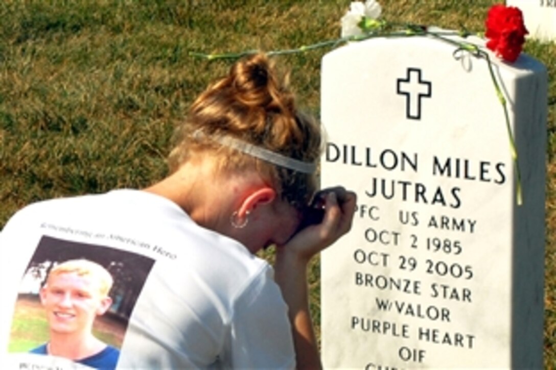 Heather Jutras Glasgow grieves at her brother's grave in Arlington National Cemetery, Aug. 24, 2008. She, her mother, father and younger brother participated in the last day of "Run for the Fallen," a cross-country memorial event to honor troops who died in Operation Iraqi Freedom. 