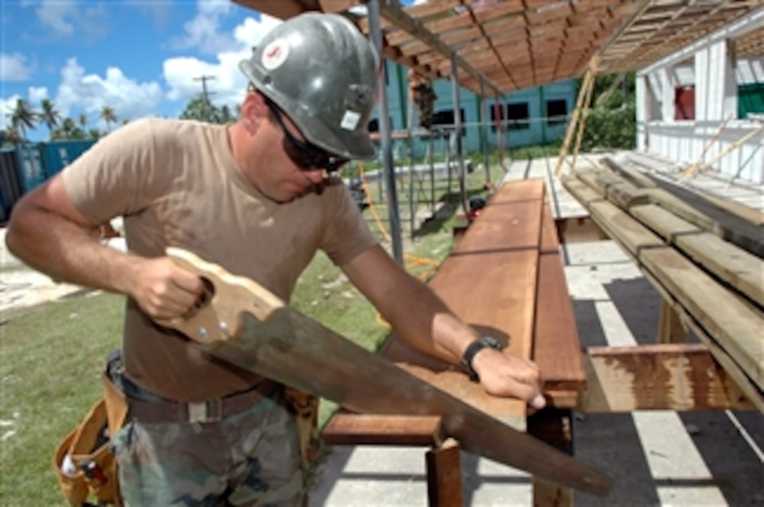 U.S. Navy Petty Officer 2nd Class Gabriel Kelley of Navy Mobile Construction Battalion 133 cuts wood planks for the reconstruction of Mwan Elementary School during a Pacific Partnership engineering civic action program in Chuuk, Federated States of Micronesia, on Aug. 23, 2008.  The Pacific Partnership construction team is assisting five different countries, renovating schools, hospitals, and medical clinics.  