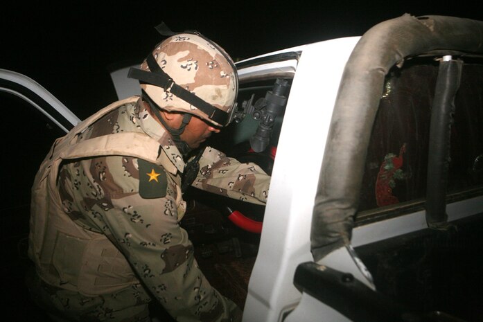 2nd Lt. Rahim Sahid, an infantry officer with 3rd Battalion, 29th Iraqi Army Brigade, searches a vehicle during at a vehicle check point in western al-Anbar province, Iraq. The soldiers assumed control of an area in western al-Anbar province at the beginning of August from 2nd Light Armored Reconnaissance Battalion, Regimental Combat Team 5.  The Iraqi battalion has conducted patrols near Rutbah, allowing the Iraqi Police to focus within the city. ::r::::n::