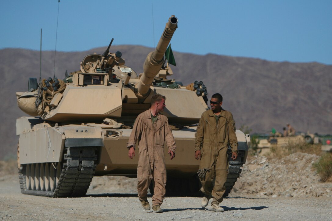 An M1A1 Main Battle Tank from 1st Tank Battalion's Company C, engages light armored targets with explosive anti-tank rounds during the battalion's bi-annual gunnery qualification at Range 500 Aug. 26. The Marines have been off of their tanks for more than a year after deploying to Iraq with a provisional mission of providing Main Supply Route security.