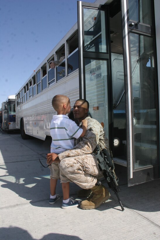 Staff Sgt. Verice Bennett, platoon sergeant, Company I, 3rd Battalion, 7th Marine Regiment, shares one last hug with his son, Sekye, at the Combat Center’s Unit Marshalling Area before leaving for duty in Iraq Aug. 26. Marines and sailors from 3/7 departed the Combat Center Aug. 26 and 27 on a seven-month deployment to Iraq in support of Operation Iraqi Freedom.  More than 1,000 Marines and sailors left the Unit Marshalling Area in the early and mid-morning hours of both days to the waves and tears of their families and loved ones.