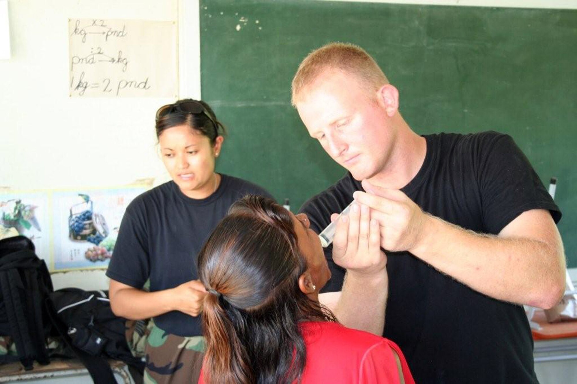 Tech. Sgt. Brad Mortenson gives a patient medicine during a 934th Aeromedical Staging Squadron deployment to Suriname in the summer of 2008. Sergeant Mortenson and 22 other reservists from the Air Force Reserve unit at Minneapolis-St. Paul International Airport Air Reserve Station, Minn., along with 18 others provided health care as part of the Beyond the Horizons program in Suriname. (U.S. Air Force photo/Maj. Jerry Hall)