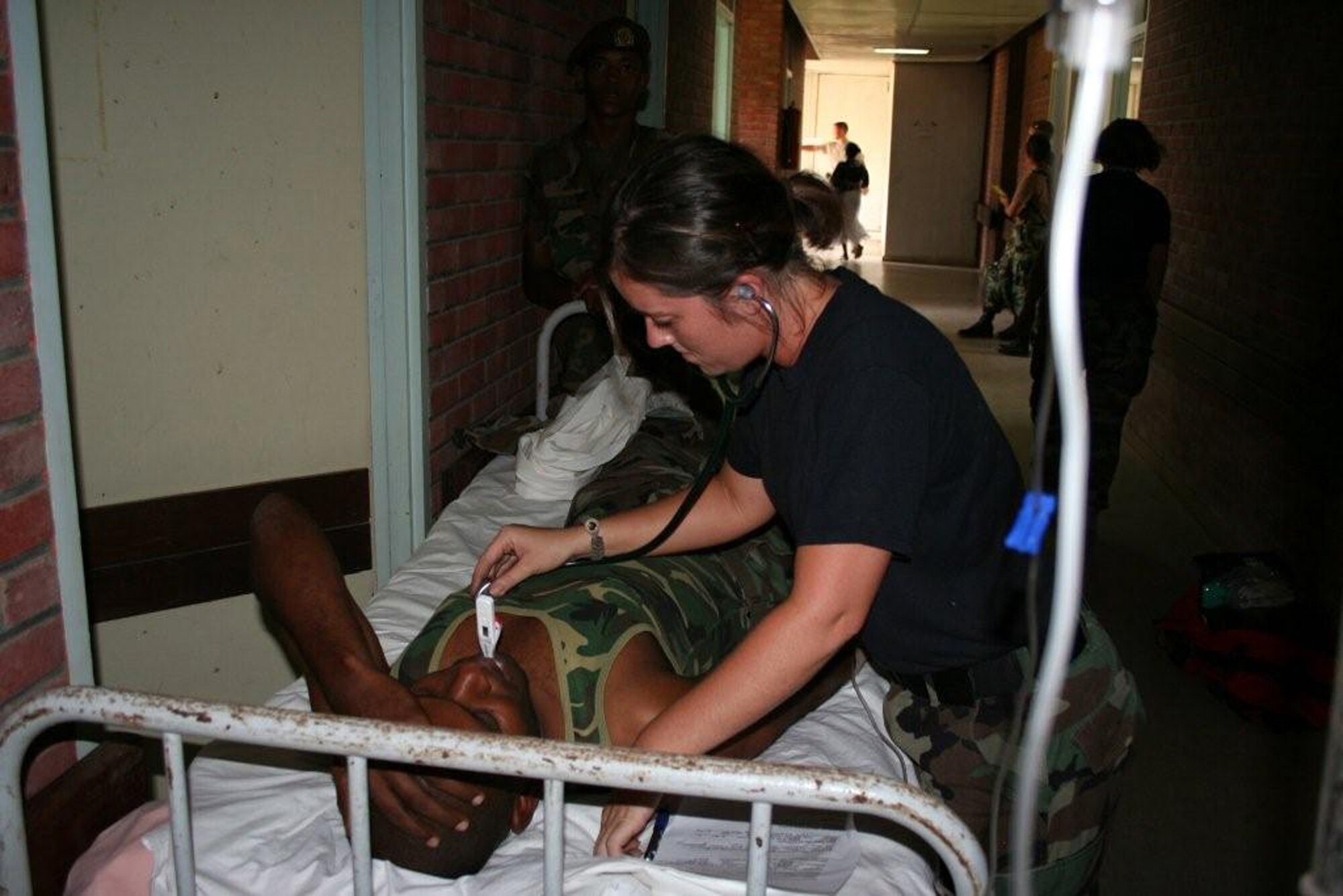Staff Sgt. Mackenzie Schroeder of the 934th Aeromedical Staging Squadron, Minneapolis-St. Paul International Airport Air Reserve Station, Minn., takes care of a Surinamese soldier who came down with Shigella's disease during the sergeant's deployment to Suriname in the summer of 2008. (U.S. Air Force photo/Maj. Jerry Hall)

