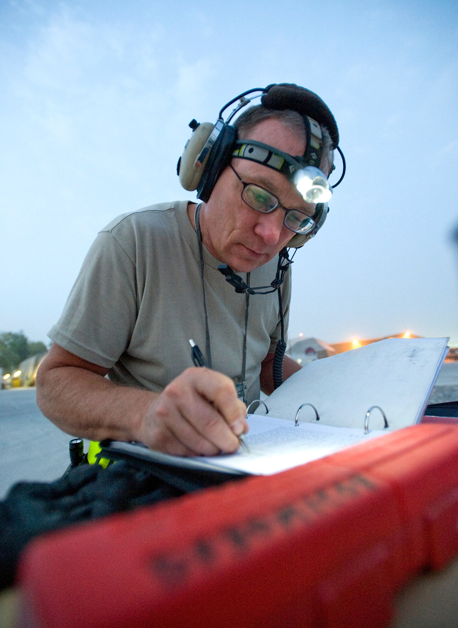 Master Sgt. William St. Clair updates maintenance records on an HH-60 Pave Hawk before a flight Aug. 15 at Kandahar Air Base, Afghanistan. Sergeant St. Clair is a crew chief on the HH-60. The aircraft as well as the crews who fly and maintain it are assigned to the 305th Expeditionary Rescue Squadron from Davis-Monthan Air Force Base, Ariz. (U.S. Air Force photo/Master Sgt. Keith Brown) 
