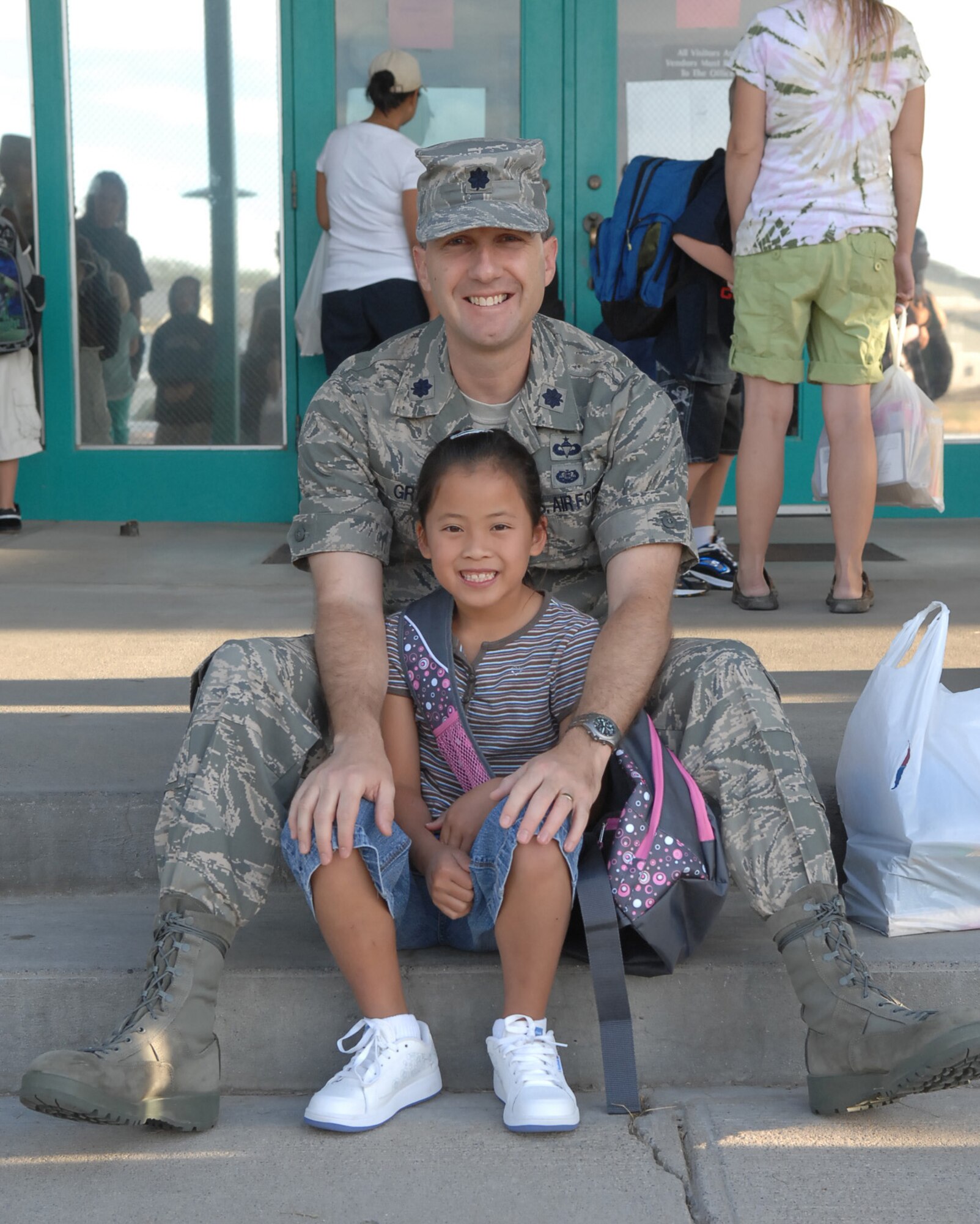 MOUNTAIN HOME AIR FORCE BASE, Idaho - Lt. Col. Matthew Grant, 366th Fighter Wing legal office, sits on the steps with his daughter outside of the Base Primary School Aug. 25. Today is the first day of school for the 2008-2009 school year on Mountain Home Air Force Base. (U.S. Air Force photo/ Airman Deborah Young)