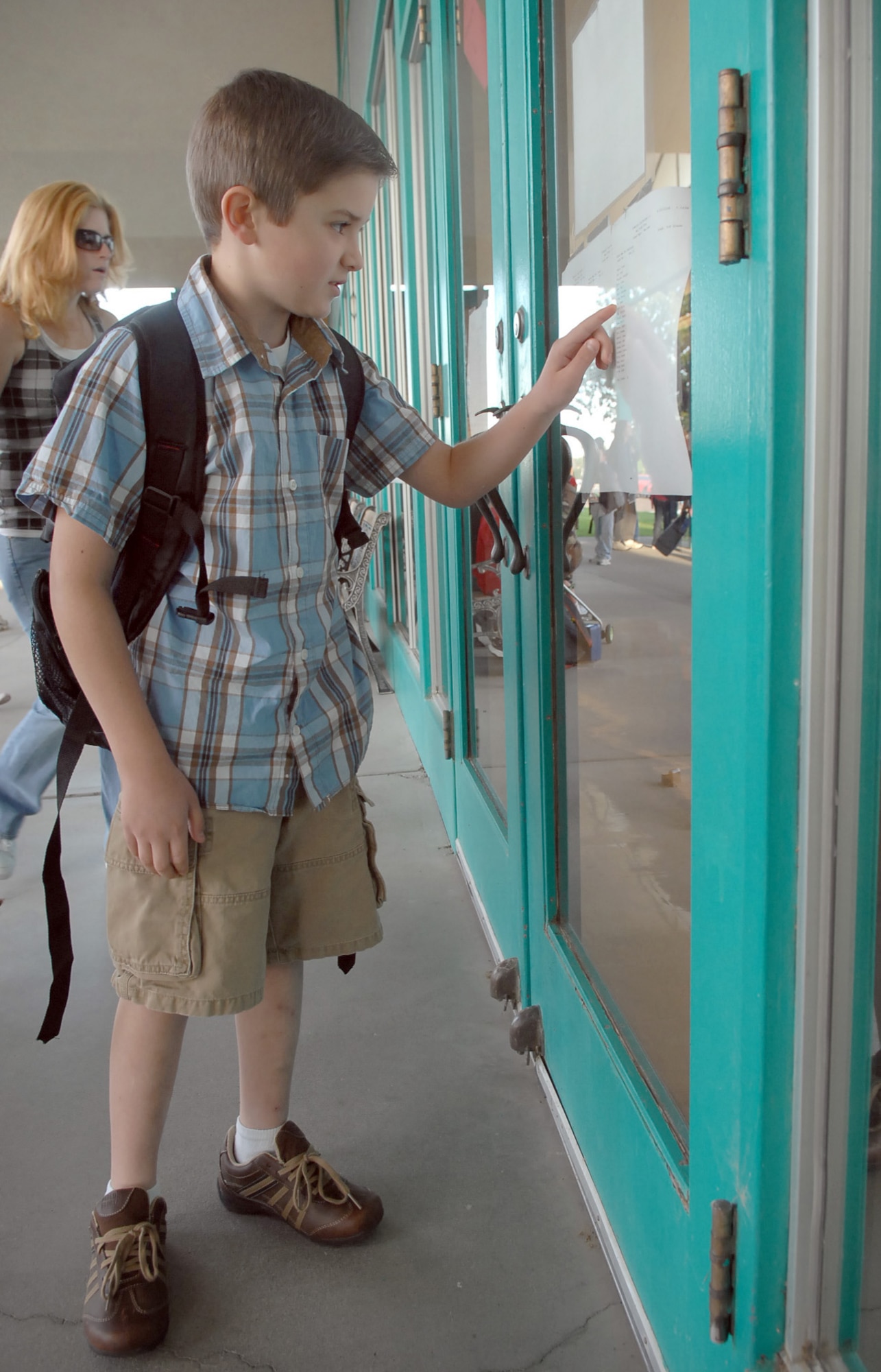 MOUNTAIN HOME AIR FORCE BASE, Idaho -- Samuel Ivey checks a list to see which teacher and classroom he has been assigned for the new year at the Base Primary School which began Aug. 25. “My son, Samuel, is happy to get back to school so he can see some of his friends he has missed over the summer,” said Staff Sgt. Katie Klefforth, 366th Aircraft Maintenance Squadron. (U.S. Air Force photo/Airman Deborah Young)