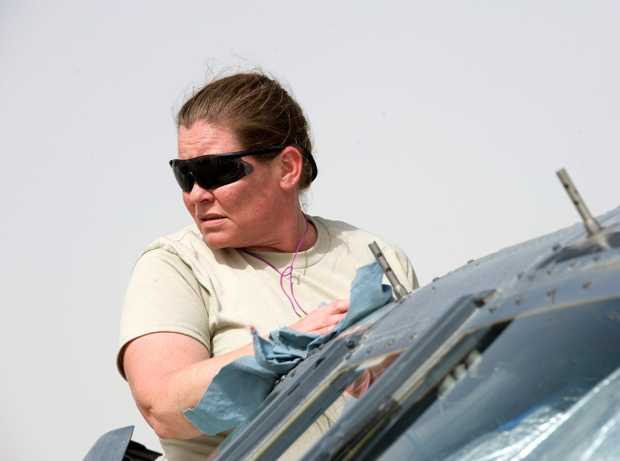Tech. Sgt. Joyce Lee cleans windows on an HH-60 Pave Hawk Aug. 15 at Kandahar Air Base, Afghanistan. The HH-60 and crews who fly and maintain it are assigned to the 305th Expeditionary Rescue Squadron deployed from Davis-Monthan Air Force Base, Ariz. (U.S. Air Force photo/Master Sgt. Keith Brown) 
