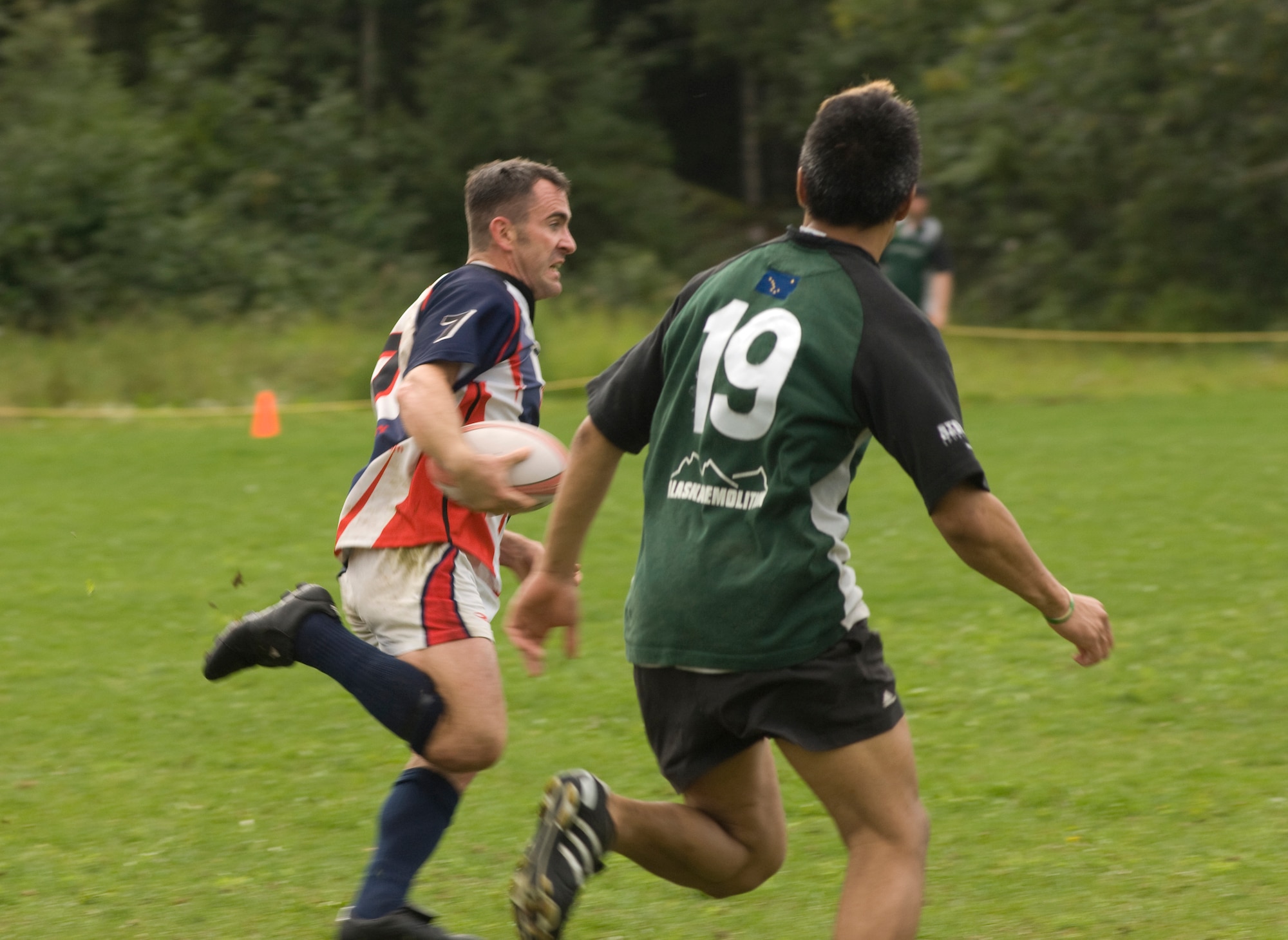 ANCHORAGE, Alaska -- Bryan Pemberton, 3rd Contracting Squadron, tries to aviod members of the Spenard Dragons during the championship game at Davis Field Aug. 23. The team won the championship game 30-12, finishing off an unbeaten season. Pemberton was selected to the 2008 Air Force rugby team. (U.S. Air Force photo/Airman 1st Class David Carbajal)