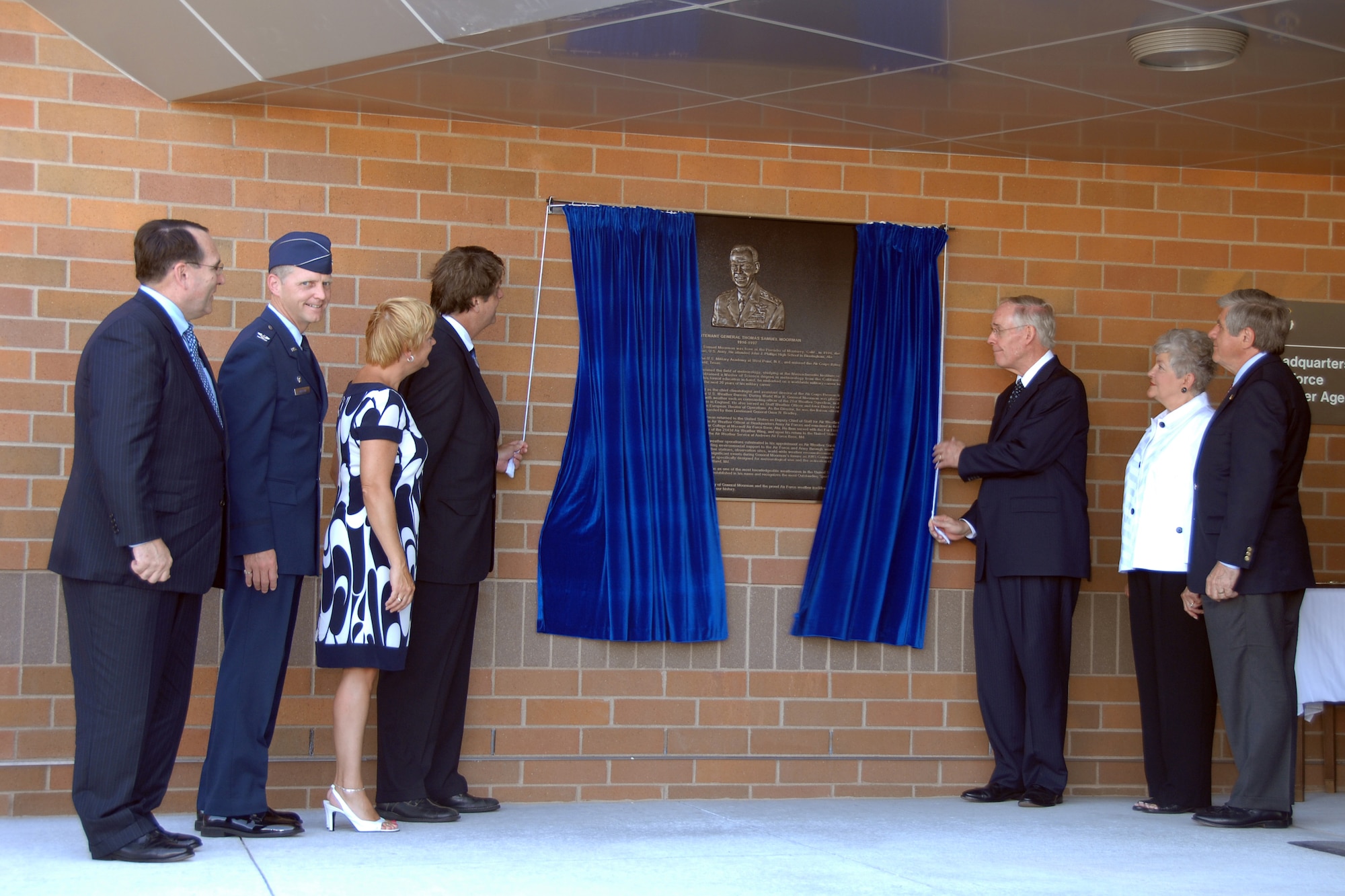 OFFUTT AIR FORCE BASE, Neb. -- Mr. Robert Moorman, left, and Retired Gen. Thomas S. Moorman Jr., right, pull back the curtain to unveil a plaque dedicating the new Air Force Weather Agency headquarters building to Lt. Gen. Thomas S. Moorman during a ceremony here Aug. 22. The new building is one of Air Combat Command's first Leadership in Energy and Environmental Design green rated facilities. (U.S. Air Force Photo by Kevin Schwandt)