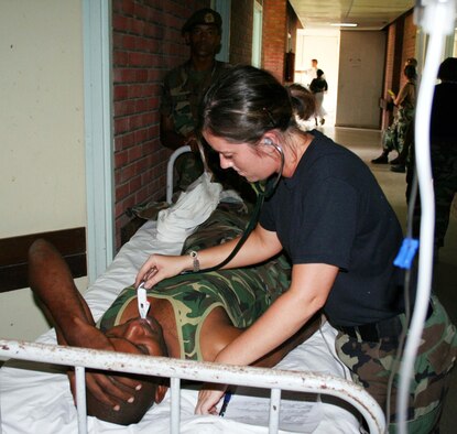 Tech. Sgt. Mackenzie Schroeder, 934th Aeromedical Staging Squadron, takes care of a Surinameese soldier who succumbed to Shigella?s disease. See story on page 7. (Air Force Photo/Maj. Jerome Hall)