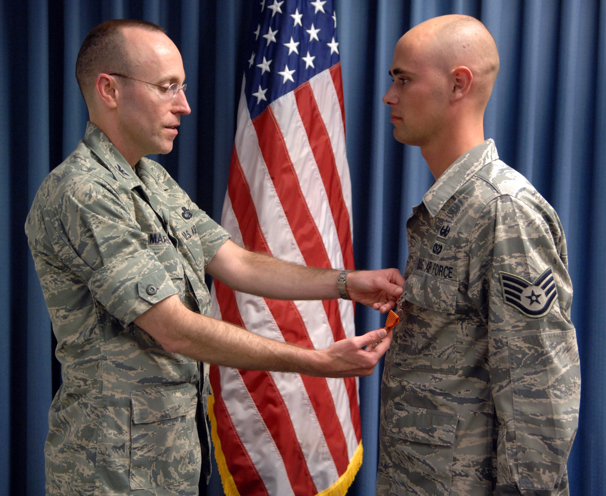MOUNTAIN HOME AIR FORCE BASE, Idaho - Staff Sgt. James Adams, 366th Civil Engineer Squadron explosives ordnance disposal, receives his Combat Action Medal from Col. Jeffrey Maxwell, 366th Mission Support Group commander, during a ceremony Aug. 20. The medal was created to recognize Air Force members who were engaged in air or ground combat off base in a combat zone. This includes members who were under direct and hostile fire, or who personally engaged hostile forces with direct and lethal fire. (U.S. Air Force photo / Airman 1st Class Ashley Winters)