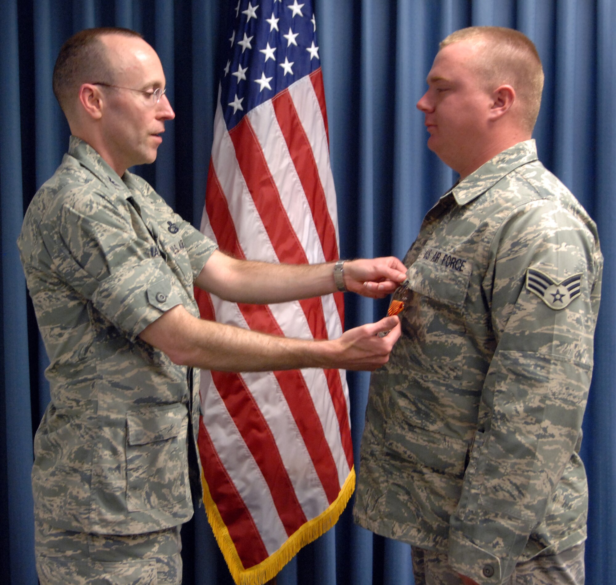 MOUNTAIN HOME AIR FORCE BASE, Idaho - Senior Airman Kevin Ingerick, 366th Logistics Readiness Squadron vehicle operator dispatcher, receives his Combat Action Medal from Col. Jeffrey Maxwell, 366th Mission Support Group commander, during a ceremony Aug. 20. The medal was created to recognize Air Force members who were engaged in air or ground combat off base in a combat zone. This includes members who were under direct and hostile fire, or who personally engaged hostile forces with direct and lethal fire. (U.S. Air Force photo / Airman 1st Class Ashley Winters)