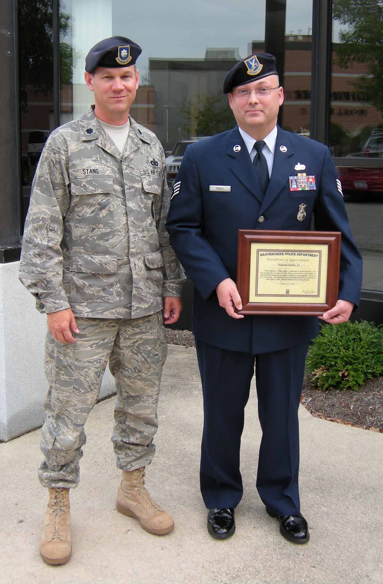 Lt. Col. Paul Stang, 88th Security Forces Squadron commander at Wright-Patterson Air Force Base, stands outside the Beavercreek, Ohio municipal building with Staff Sgt. Noland Noble, Jr., after Noble was honored August 25 by Beavercreek Police Chief John Turner.  Noble's fast actions while off-duty rendering aid to the victim of a purse snatching in July contributed to the capture of two suspects sought for a number of crimes.  (U.S. Air Force photo/Derek Kaufman)