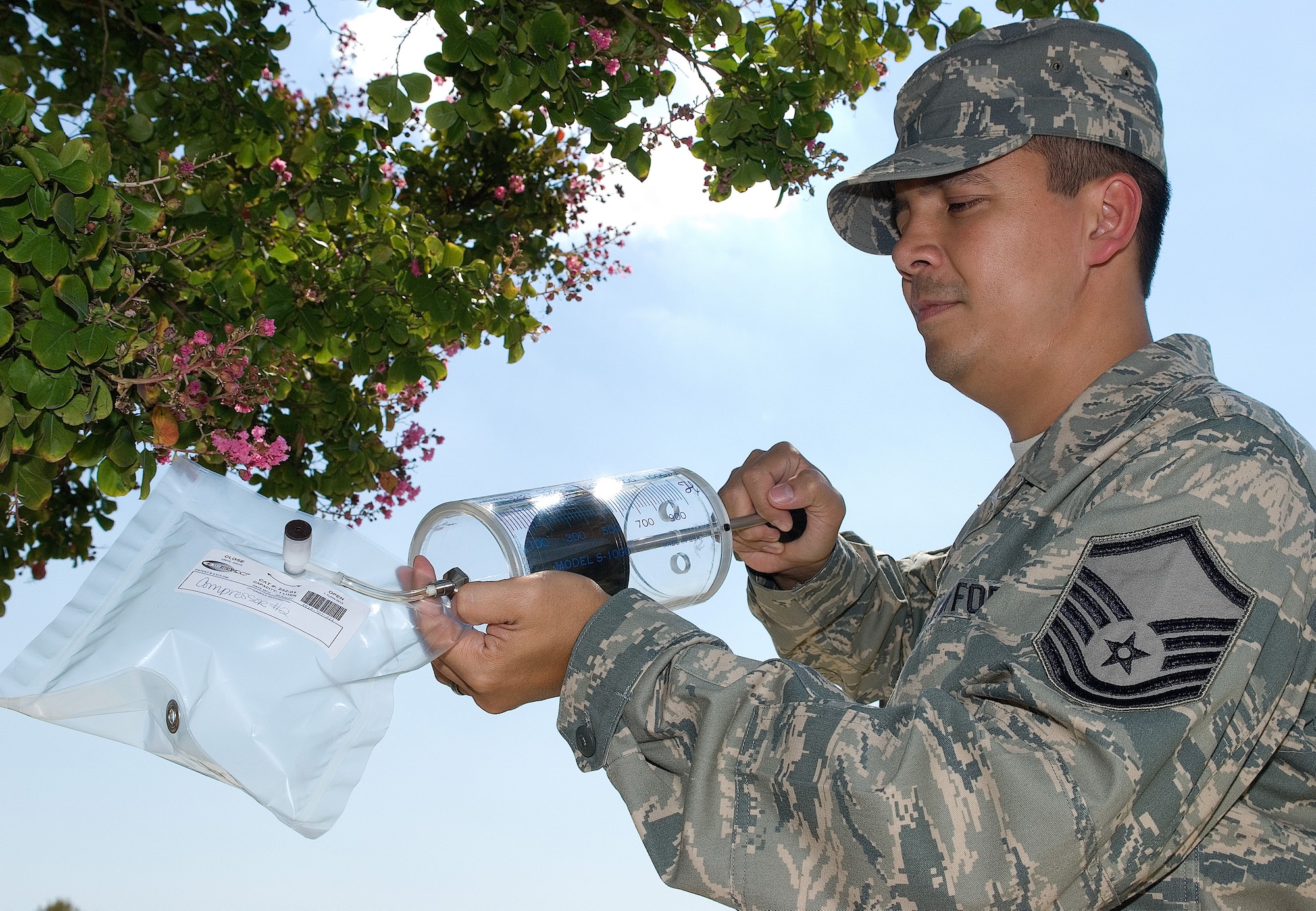 DOVER AIR FORCE BASE, Del. – Master Sgt. John Rinker, 436th Aerospace Medicine Squadron Bioenvironmental Engineering NCO in-charge, uses a syringe to fill an air sampling bag, which tightly seals in the air. The 436th AMDS BEEs collect samples of the air, water, soil and more around Dover AFB to detect and identify hazards around the base. (U.S. Air Force photo/Roland Balik) 