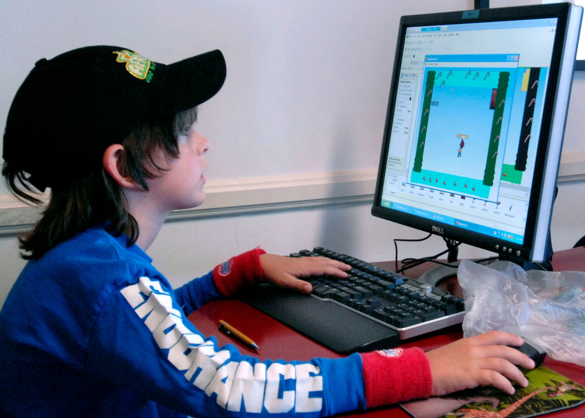 Sean Leppellere, son of Lt. Col. Anthony Leppelle, Space and Missile Systems Center Contracting, is learning to manipulate and construct a computer game as part of the Youth Summer Camp, Technology Week at Fort Mac  Arthur Youth Center, Aug.18-22.  (Photo by Lou Hernandez)