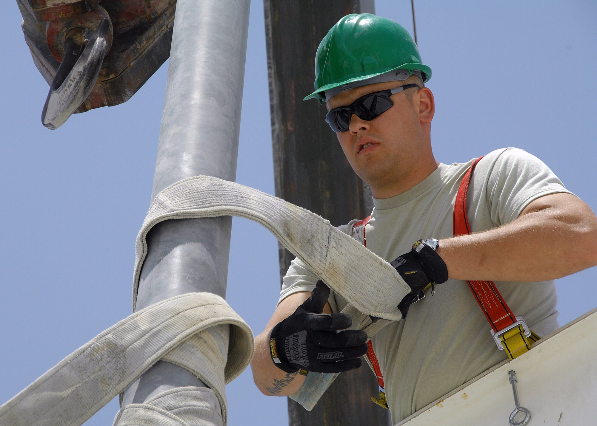 Senior Airman Blake Kelsey removes a harness strap from a light pole Aug. 23 at an air base in Southwest Asia.    He is assigned to the 386th Expeditionary Civil Engineer Squadron, and deployed from the Utah Air National Guard. (U.S. Air Force photo/Tech. Sgt. Raheem Moore) 