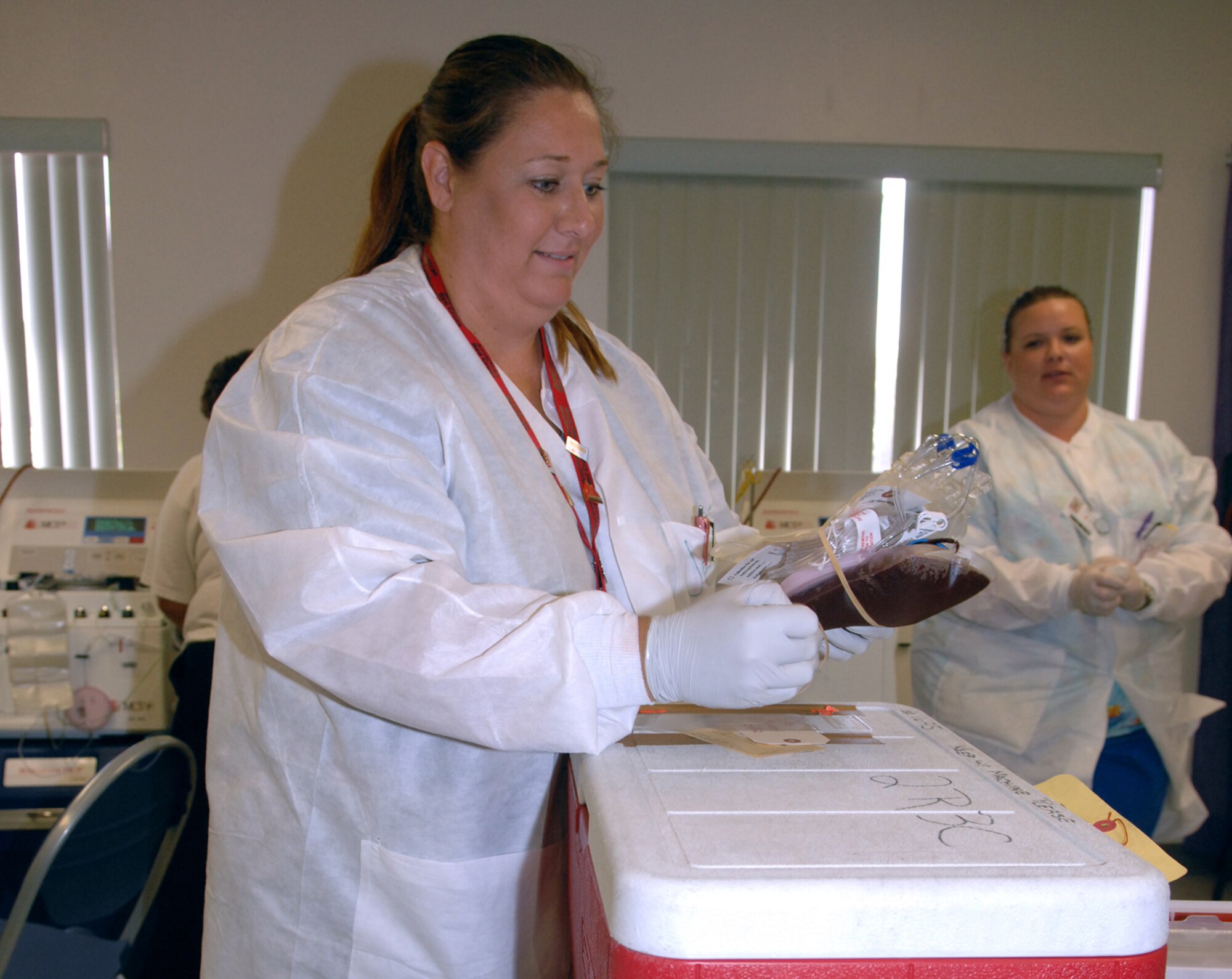 Jeanette Mallis, an American Red Cross donor service technician, processes and backs 360 grams of red blood cells at the ARC blood drive here Aug. 20. (U.S Air Force photo by Airman 1st Class Jamie L. Coggan)