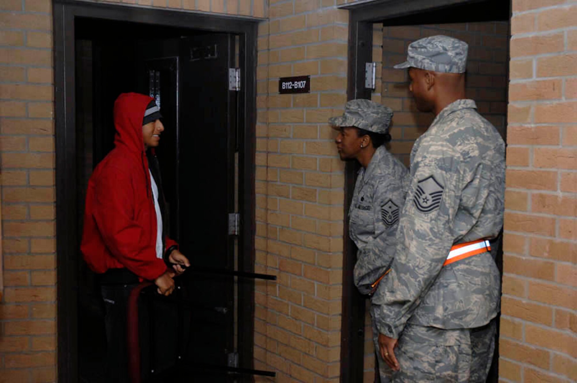 Master Sgt. Dionne Turner, 48th Logistics Readiness Squadron first sergeant and Master Sgt. Ian Batchelor, 48th Dental Squadron first sergeant chat with Airman 1st Class Philip Hernandez, 48 LRS about his night out Aug. 15 at RAF Lakenheath, England. First sergeants and the 48th Fighter Wing Command Chief wanted to show a presence in the dorms to increase Airmen awareness and help foster the wingman program. (U.S. Air Force photo by Senior Master Sgt. Thomas Wood)