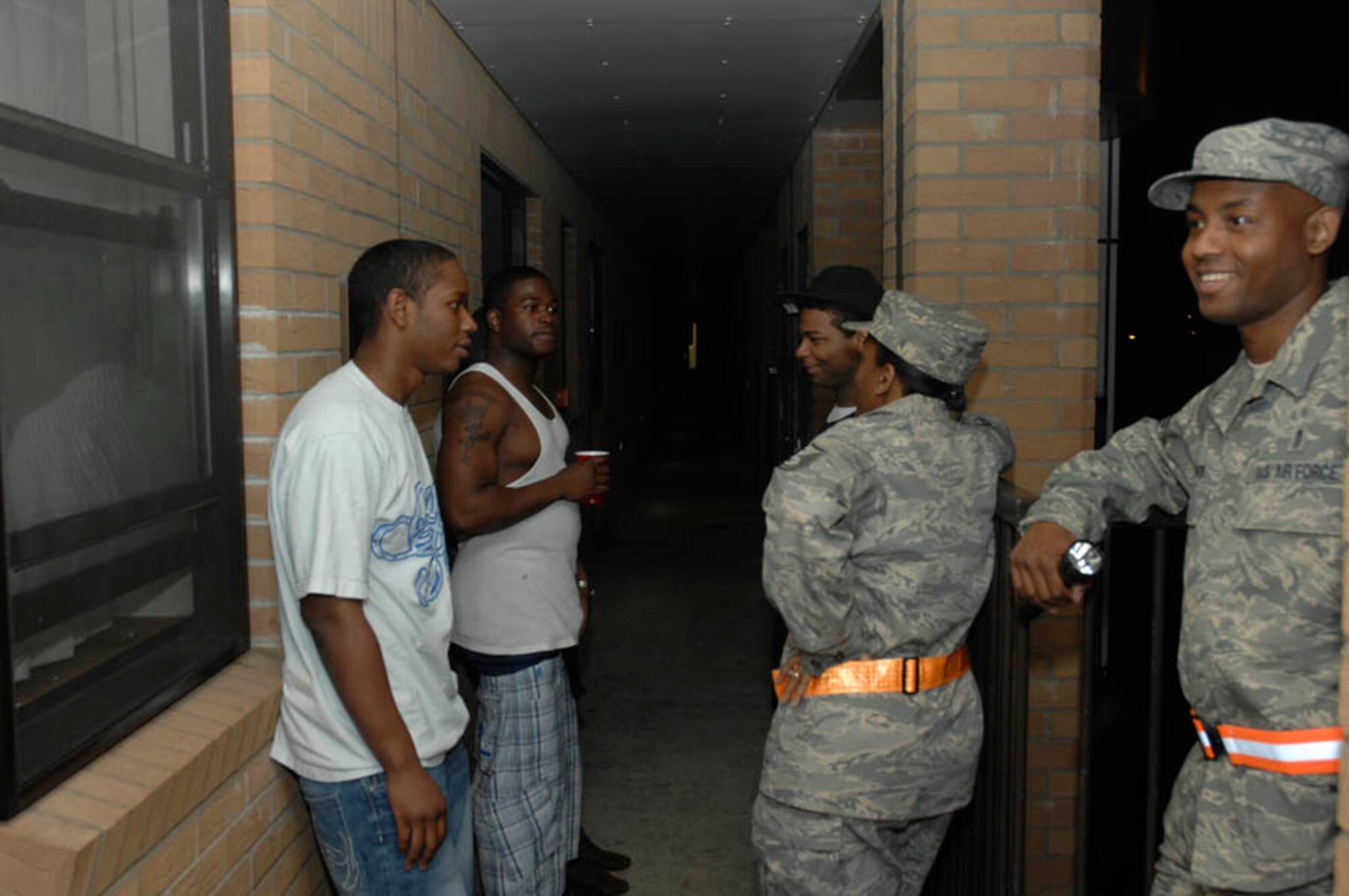 Master Sgt. Dionne Turner, 48th Logistics Readiness Squadron first sergeant and Master Sgt. Ian Batchelor, 48th Dental Squadron speak with dormitory residents Aug. 15 at RAF Lakenheath, England. 48th Fighter Wing Command Chief Jeffrey Williams with first sergeants from various squadrons visited the dormitories and Liberty Club in an initiative for dorm residents to feel safe in their living quarters and witness the wingman concept in action.(U.S. Air Force photo by Senior Master Sgt. Thomas Wood)