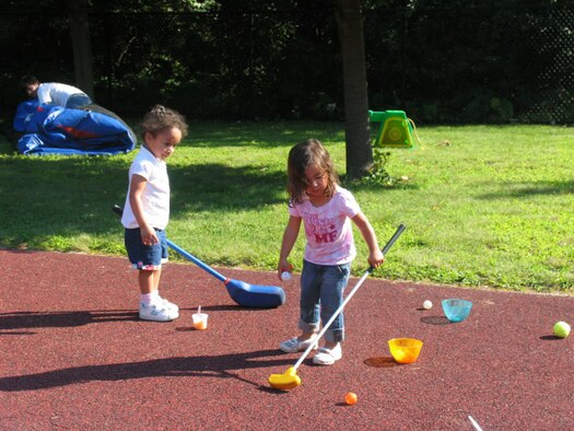 HANSCOM AFB, Mass. – Genesis Sandoval (left) and Haley Poblete (right) try out a golf game at the Child Development Center’s Summer Carnival on Aug. 22. The carnival offered an opportunity for children to participate in a number of activities such as face painting, games, crafts and a bouncy castle with their parents and caregivers. (U.S. Air Force photo by Rhonda Siciliano)