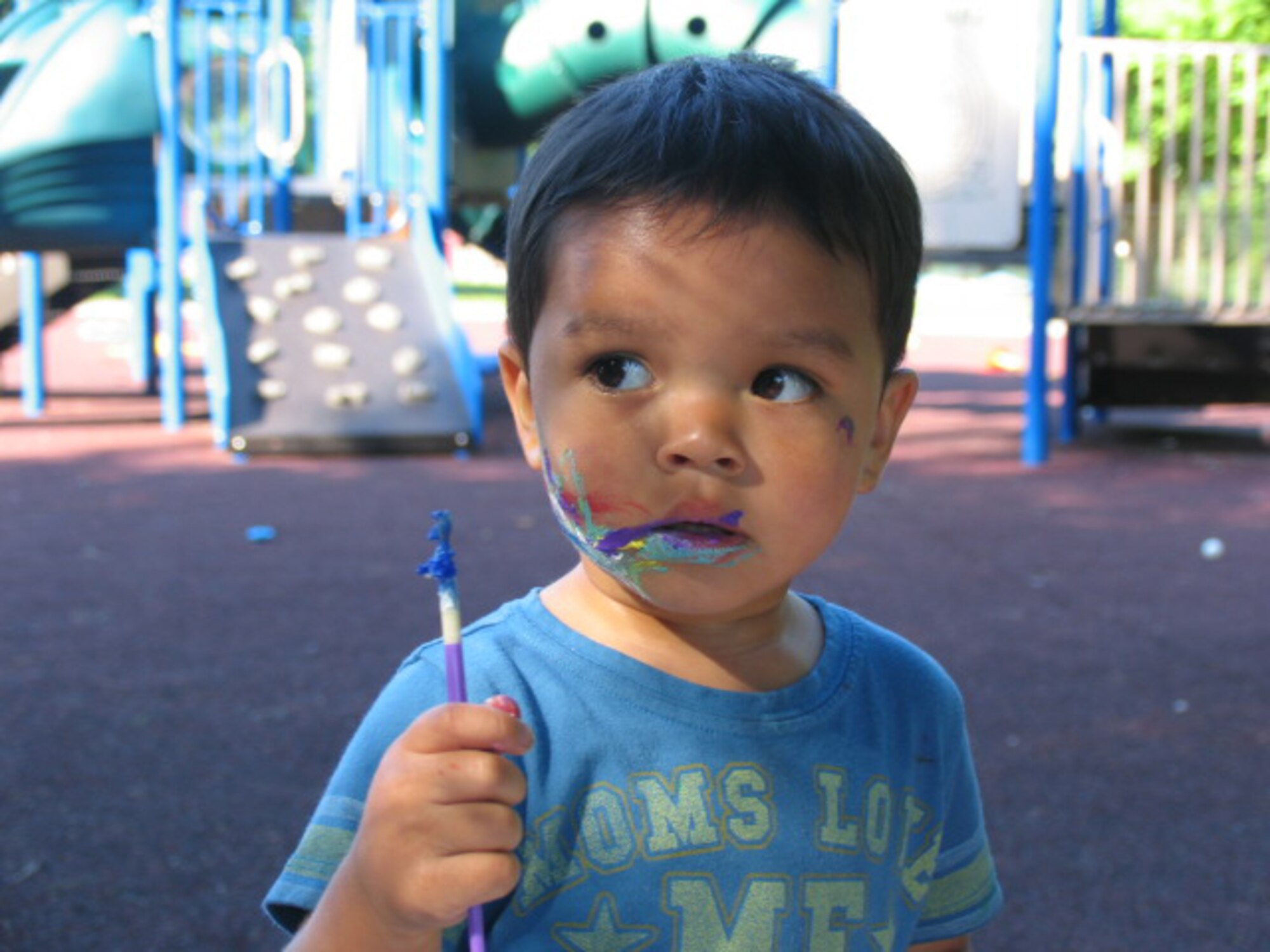 HANSCOM AFB, Mass. – Andre Jackson pauses from face painting during the Child Development Center’s Summer Carnival on Aug. 22. (U.S. Air Force photo by Rhonda Siciliano)