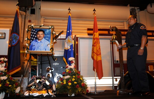 ANDERSEN AIR FORCE BASE, Guam - An Andersen Fire and Emergency Services flight member rings the "Last Alarm" for Frank Barnes' memorial service Aug. 21 here. Mr. Barnes, a lead firefighter, passed away Aug. 8 from a heart attack. (U.S. Air Force photo by Airman 1st Class Courtney Witt)