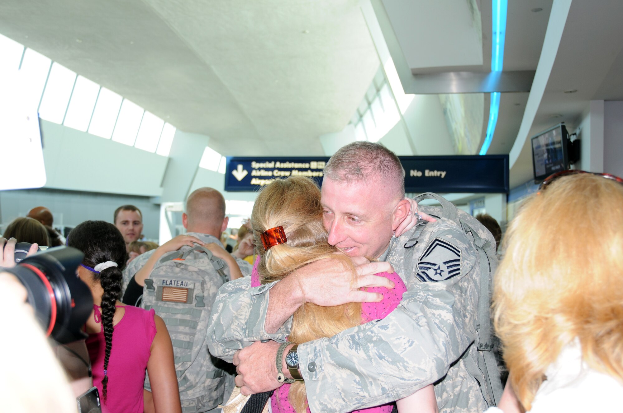 Senior Master Sgt. Paul Wiencek and his daughter embrace for the first time in six months. The sergeant and other members of the New York Air National Guards 107th Airlift Wing Security Forces Squadron just return home from Iraq after a six month deployment.(US AirForce photo/SrA Peter Dean)