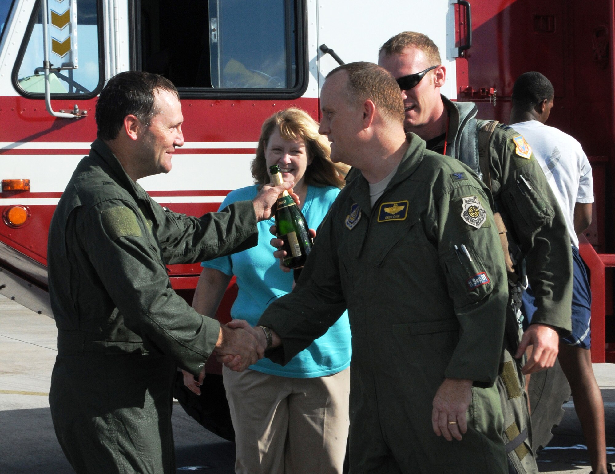 ANDERSEN AIR FORCE BASE, Guam - Brigadier Gen. Doug Owens, 36th Wing commander, shakes hands with Col. Gregory Cain, 36th WG vice commander, after his final flight here Aug. 26. General Owens flew for more than an hour over Guam and the Pacific. General Owens will relinquish command to Brig. Gen. Philip Ruhlman Sept. 2 after two years of dedicated service to the 36th WG. (U.S. Air Force photo by Airman 1st Class Courtney Witt)