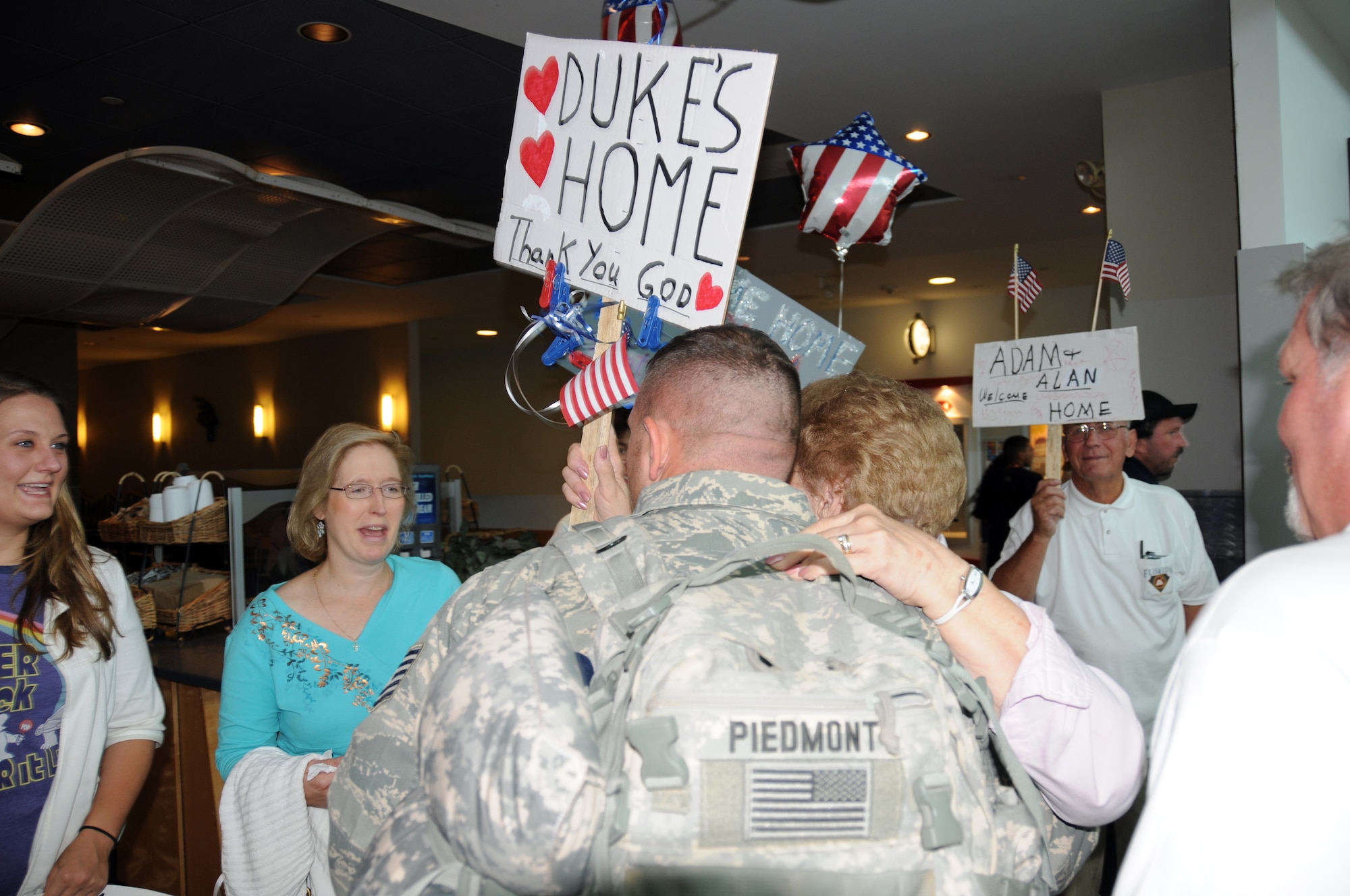 Tech Sgt. Adam ?Duke? Piedmont is greeted by his friends and family.  (U.S. Air Force photo/Senior Airman Peter Dean)