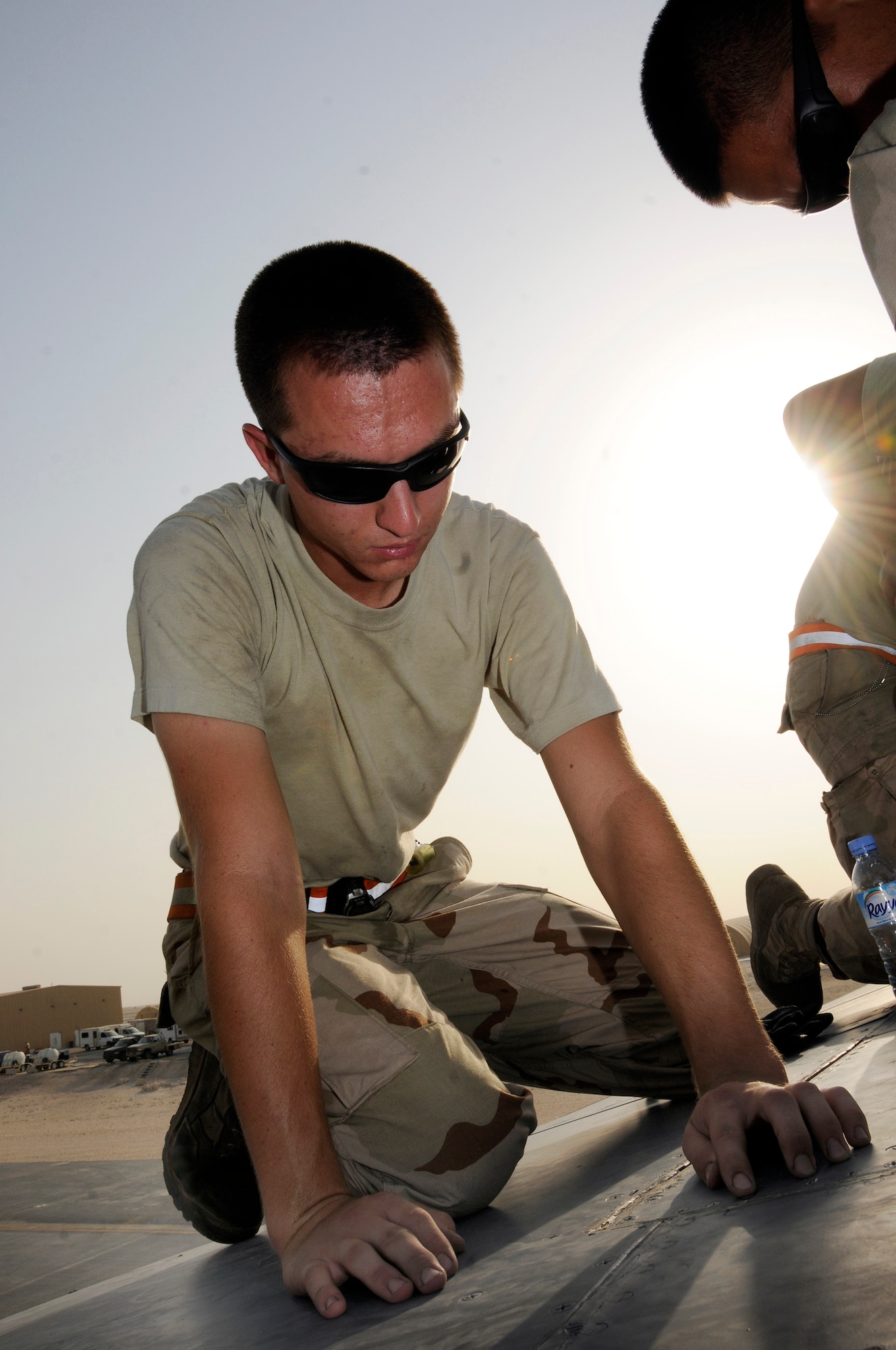 Airman 1st Class Brian Decker, a crew chief assigned to the 379th Expeditionary Aircraft Maintenance Squadron, 34th Aircraft Maintenance Unit, feels with his fingers making sure the rivets are screwed down flush on a gear screw access panel Aug. 25, 2008 at an undisclosed air base in Southwest Asia.  The access panel was removed to allow a check of the gear sweep assembly as part of a home station check.  Home station checks are performed every 800 hours of flying time, checking wear and chafing in high stress sections of the B-1 Lancer aircraft.  B-1s assigned to the 379th are regularly called upon for precision air strikes in support of Operations Iraqi Freedom and Enduring Freedom.  Airman Decker, a native of Murphy, N.C., is deployed from Ellsworth Air Force Base, S.D.  (U.S. Air Force photo by Tech. Sgt. Michael Boquette/Released)