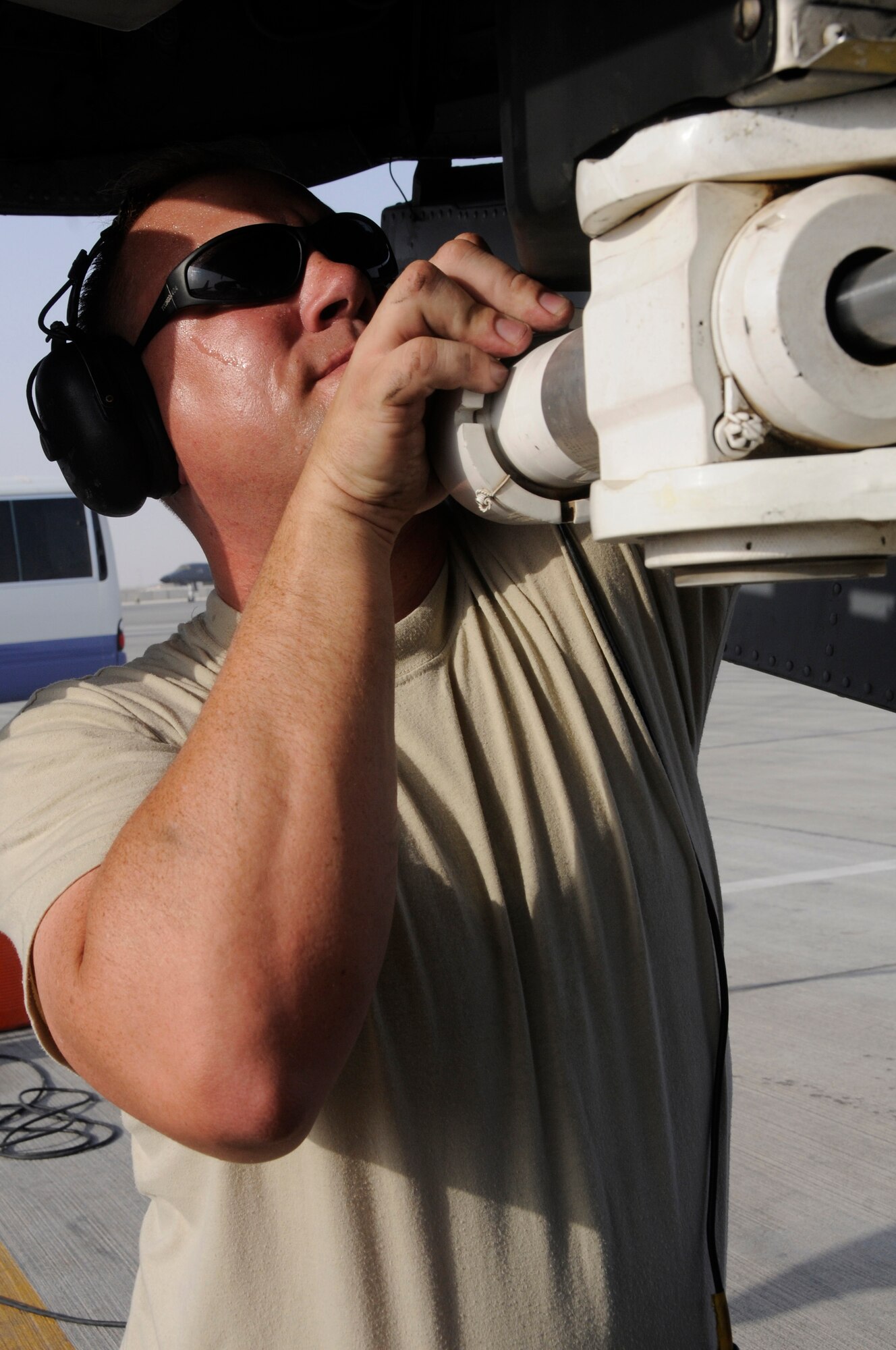 Tech. Sgt. John Young, crew chief assigned to the 379th Expeditionary Aircraft Maintenance Squadron, performs an inspection of the nose landing gear of a KC-135 Aug. 25, 2008, at an undisclosed air base in Southwest Asia. KC-135 refuelers assigned to the 379th provide aerial refueling support to Air Force, Navy, Marine Corps and allied nation aircraft engaged in Operations Iraqi Freedom, Enduring Freedom and Joint Task Force-Horn of Africa. Sergeant Young, a native of Newport News, Va., is deployed from McConnell Air Force Base, Kan. (U.S. Air Force photo by Staff Sgt. Darnell T. Cannady/Released)