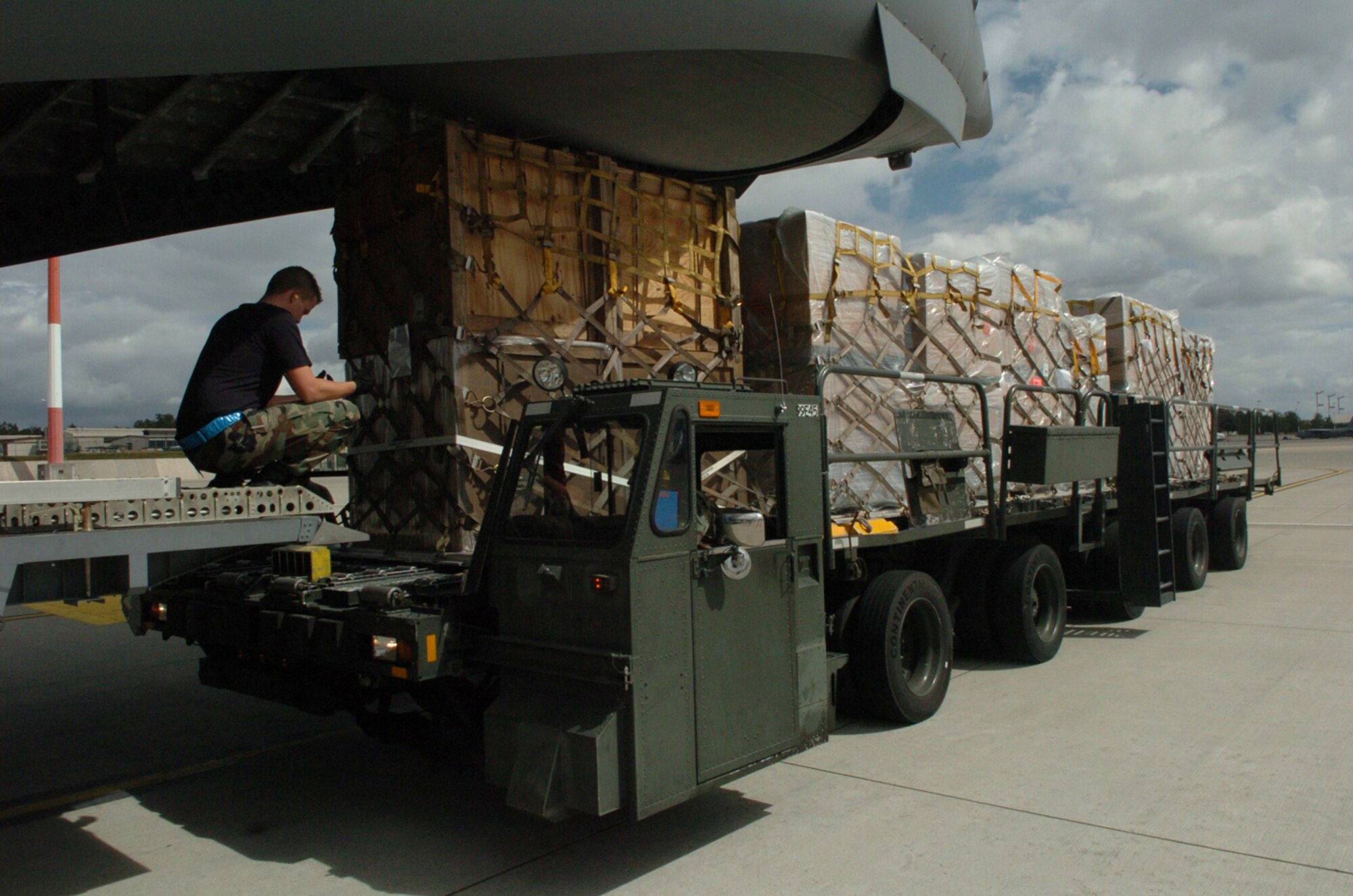 Air Force personnel from the 723rd Air Mobility Squadron moves the humanitarian supplies into position for loading in support of the humanitarian mission to Georgia.  Twentyeight Soldiers from the 66th Transportation Company, and the 39th Transportation Battalion, and Airmen from the 723rd Air Mobility Squadron worked 36 hours to palletize over 75,000 pounds of emergency shelter items and medical supplies which include tents, blankets, bedding, hygiene items, clothing, beds, cots, and medical supplies in order to support this mission to the Georgian people. (U.S. Air Force photo by Capt. Bryan Woods)(Released)