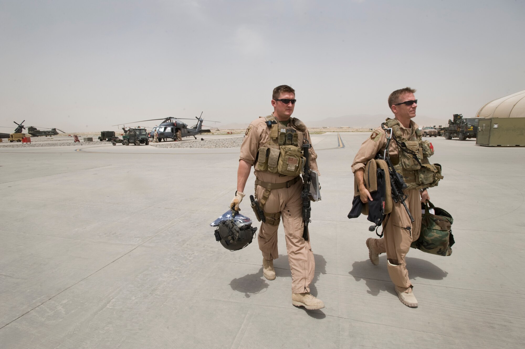 KANDAHAR AIR BASE, Afghanistan -- Staff Sgt. James Benson and Lt. Col. Paul Nevius return from a flight to test mission readiness of an HH-60 Pave Hawk helicopter at Kandahar Air Field, Afghanistan. The Pave Hawk and crews who fly it are assigned to the 305th Expeditionary Rescue Squadron an Air Force Reserve unit from Davis-Monthan Air Force Base, Ariz. Colonel Nevius is a rescue pilot and Sergeant Benson is a flight engineer. (U.S. Air Force photo by Master Sgt. Keith Brown)