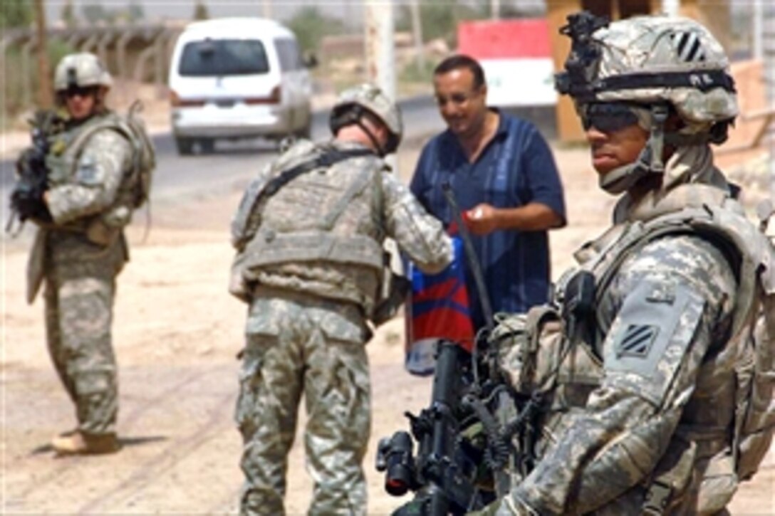 U.S. Army soldiers assess an Iraqi-run checkpoint in Al Bussay, Iraq, Aug. 20, 2008. The soldiers are assigned to the 3rd Infantry Division's 8th Cavalry Regiment. 
