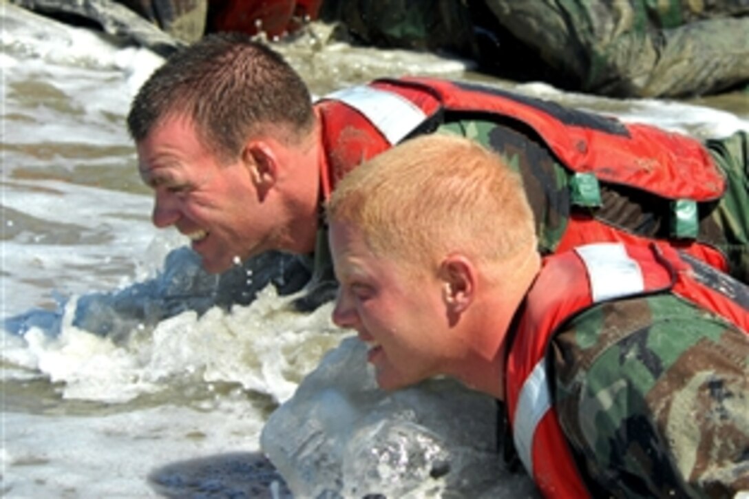 Basic crewman training students crawl through the surf during their final training evolution on Naval Amphibious Base, Coronado, Calif., Aug. 20, 2008. The final training evolution, known as the “Tour,” is a three-day, two-night training session in which the students are tested physically and mentally on what they have learned during the seven-week program. 