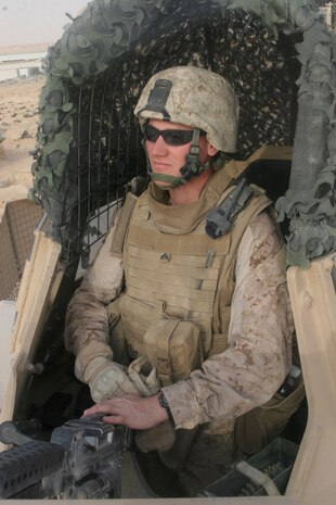 Cpl. Darnell G. Liesinger, 24, from Sioux Falls, S.D., who is a civil affairs team member with Civil Affairs team 5, 2nd Battalion, 11th Marine Regiment, Regimental Combat Team 5, sits in the turret of a mine resistant ambush protected vehicle near Rawah, Iraq, Aug. 24.  Liesinger did three previous deployments to Iraq as an infantry Marine. Liesinger is an individual ready reservist who has returned to active duty to serve as a civil affairs Marine.::r::::n::