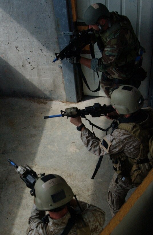Marines with Marine Special Operations Advisor Group, U.S. Marine Corps Forces, Special Operations Command, along with Army Ranger practice room clearing during the Advanced Urban Warfare portion of their training at the Direct Action Resource Center, here Aug. 25.