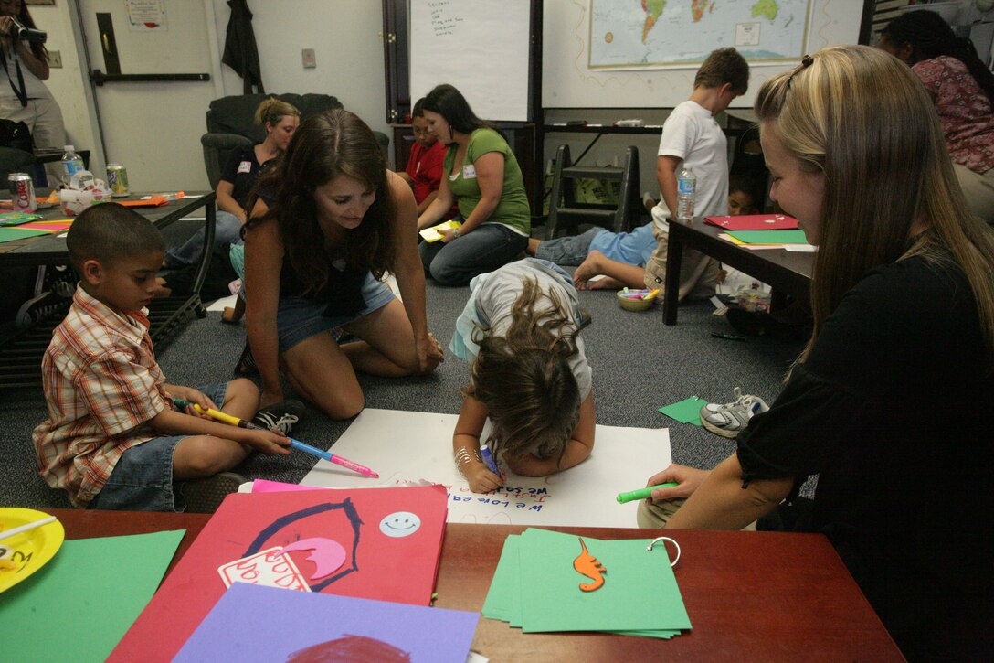 Children and group leaders of the Kid’s L.I.N.K.S. blue team write a poem about friendship during the Kid’s L.I.N.K.S., or Lifestyles, Insights, Network, Knowledge and Skills, program at the Kid’s L.I.N.K.S. building Aug. 27. This was the first L.I.N.K.S. for Kid’s session and marks the beginning of an entirely new series of L.I.N.K.S. programs aimed not only at spouses, but also at children, parents of service members and service members themselves.