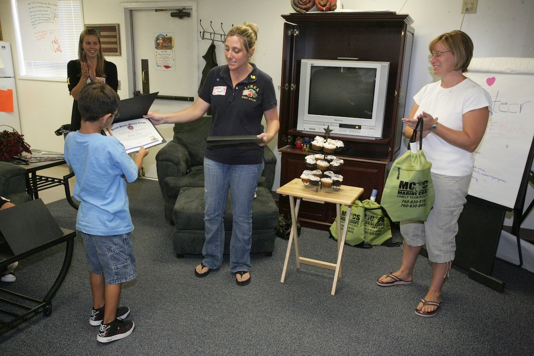Justin Silvas, son of Staff Sgt. Jesse Silvas, man power administration chief of Company A, Headquarters Battalion, receives his certificate of completion during the graduation of the first Kid’s L.I.N.K.S. class Aug. 27.   This was the first L.I.N.K.S. for Kid’s session and marks the beginning of an entirely new series of L.I.N.K.S. programs aimed not only at spouses, but also at children, parents of service members and service members themselves.
