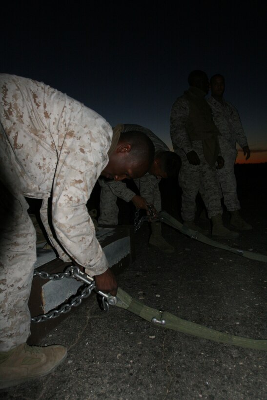 Marines from 7th Marine Regiment’s Communications and Motor Transportation platoons prepare harnesses for external loads during their final exercise to become a provisional Helicopter Support Team outside the Expeditionary Airfield Aug. 28.