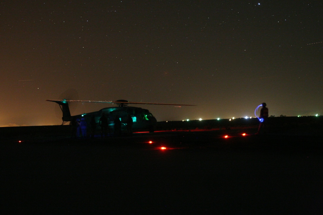 Marines from 7th Marine Regiment’s Communications and Motor Transportation platoons prepare to perform nighttime external load operations with a CH-53E Super Stallion from Marine Heavy Helicopter Squadron 361 based at Marine Corps Air Station Miramar, during their final exercise to become a provisional Helicopter Support Team outside the Expeditionary Airfield Aug. 28.